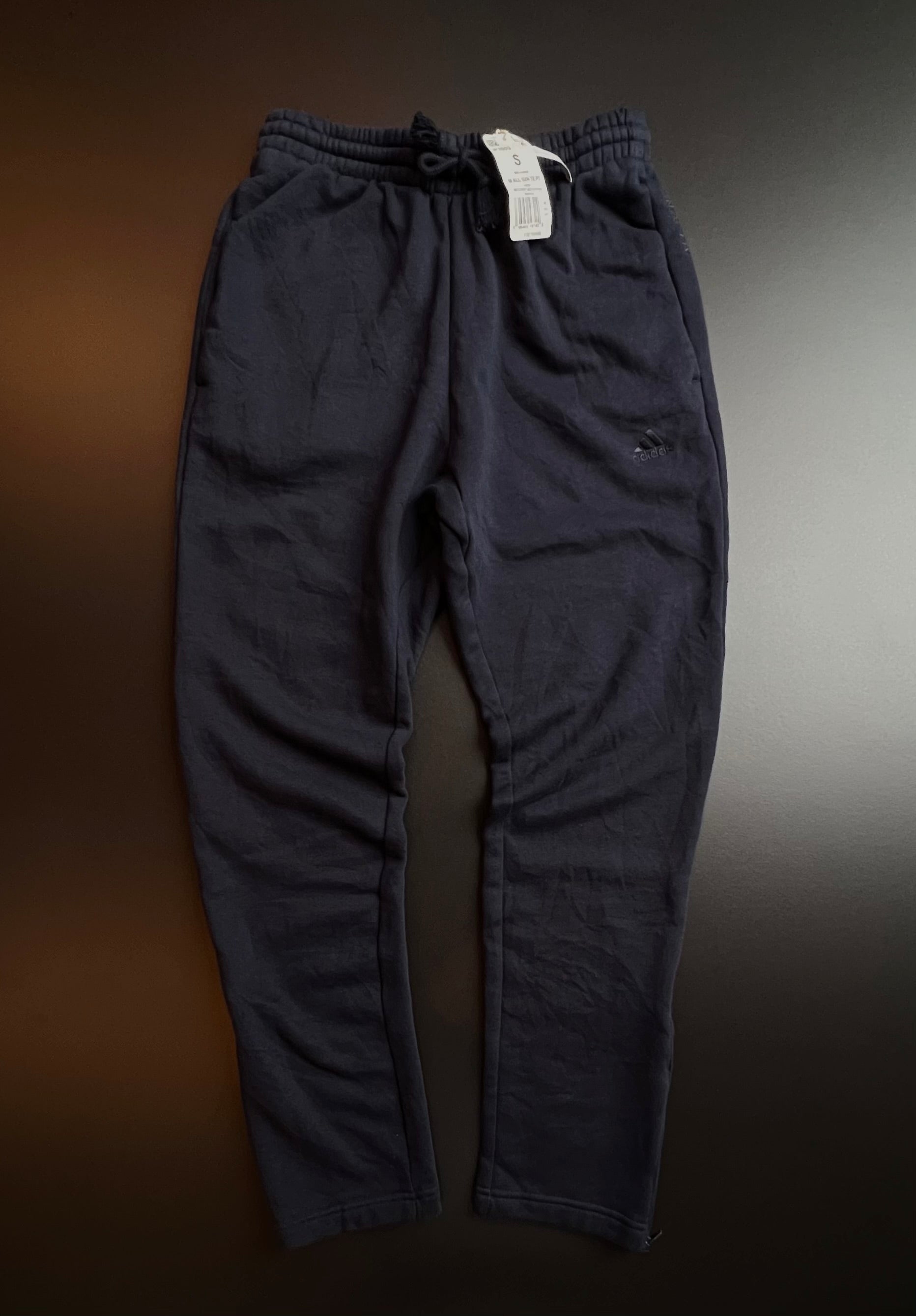 Navy blue Adidas joggers in size S, featuring a relaxed fit and elastic waistband, displayed against a neutral background.