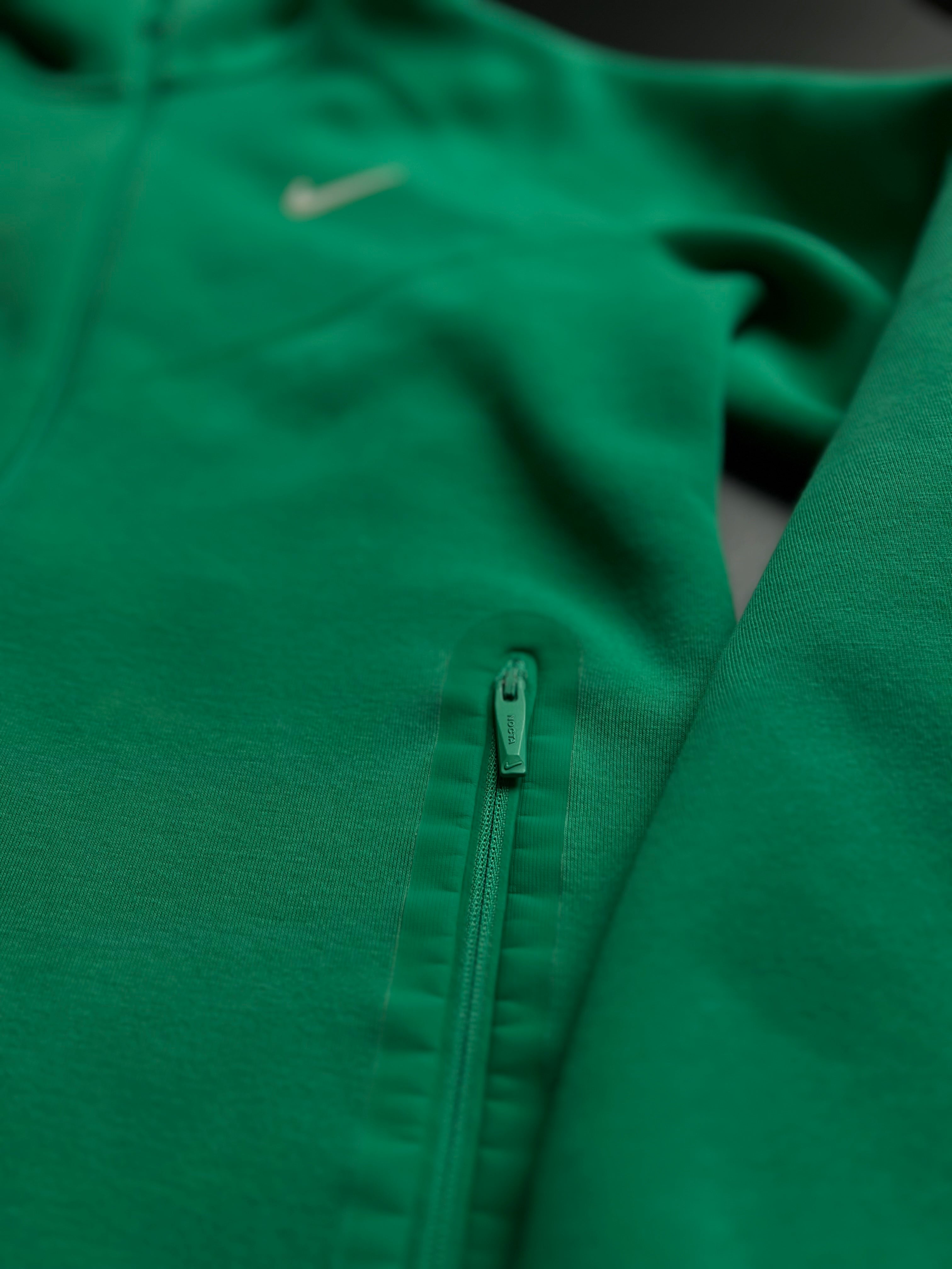 Nike NOCTA green tracksuit in size M, featuring a sleek design and comfortable fit for casual wear.