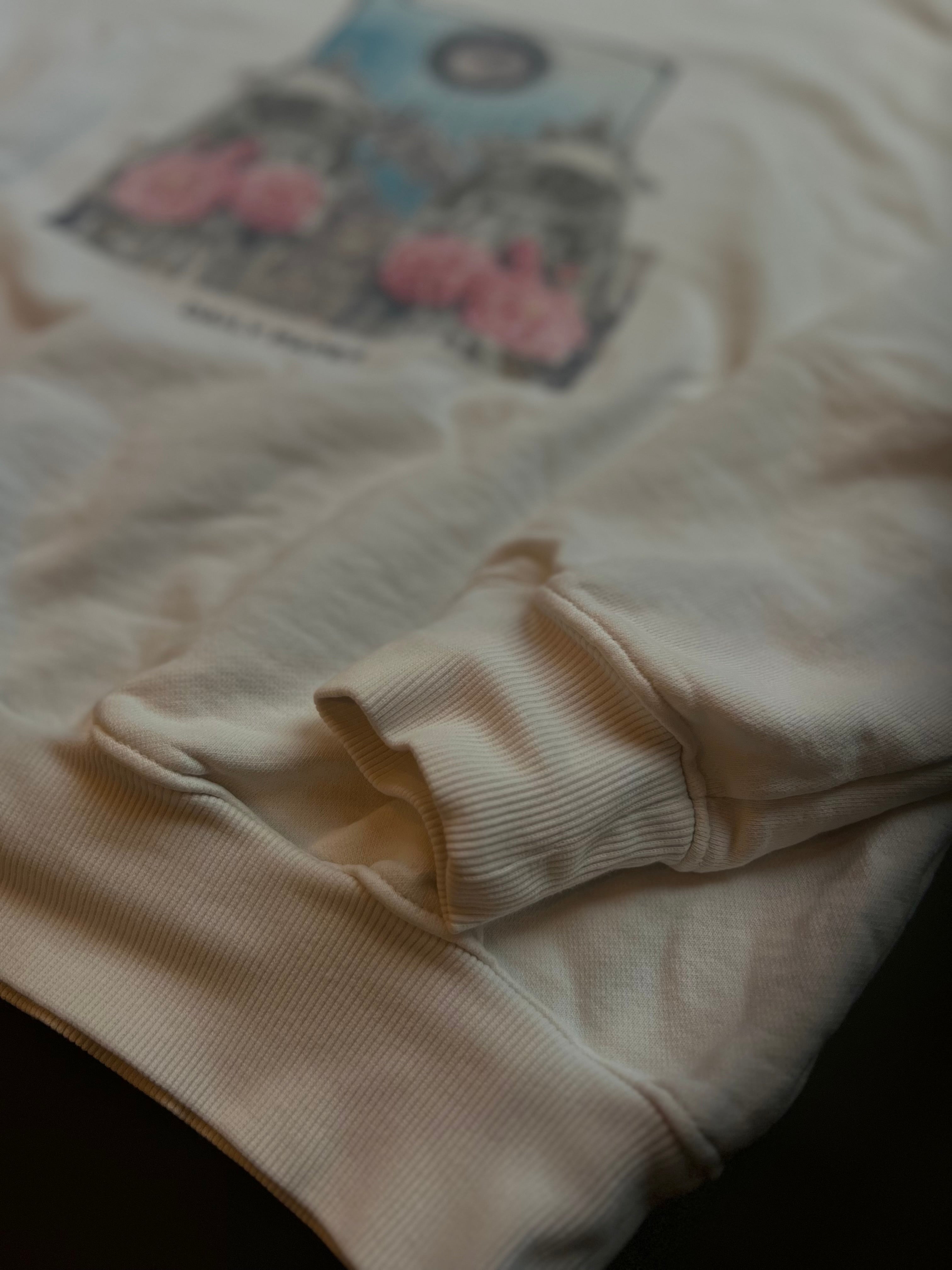 Cream white Daily Paper sweater featuring graphic print, made in Portugal, displayed on a neutral background.
