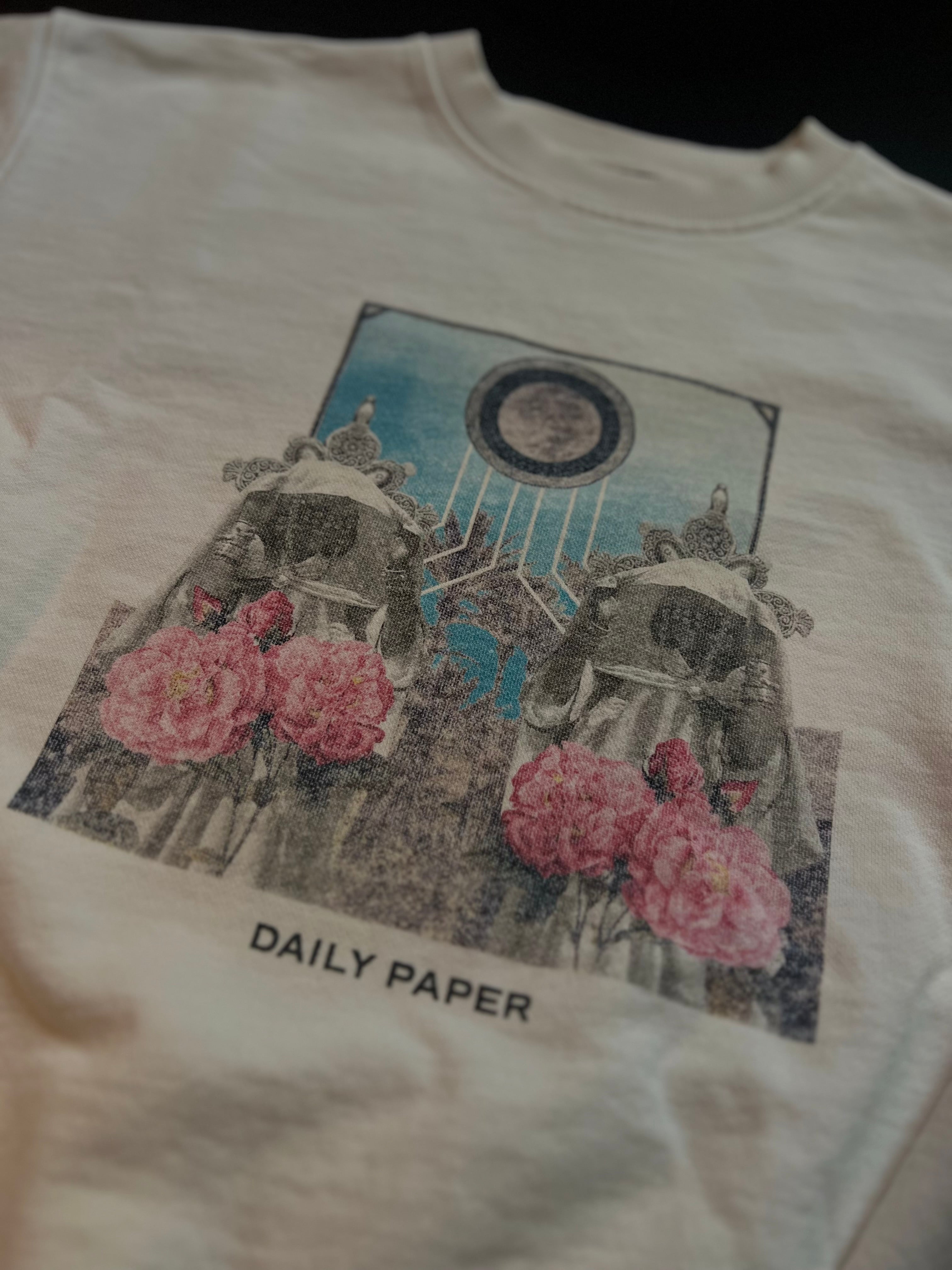 Cream white Daily Paper sweater with graphic print, made in Portugal, displayed on a hanger against a neutral background.